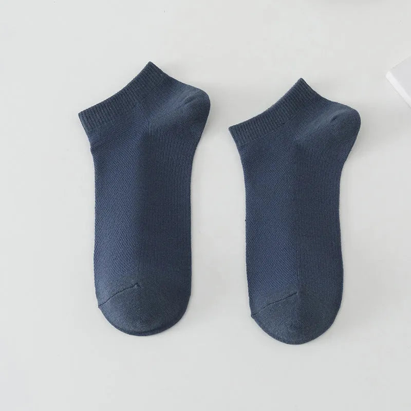 A pair of solid colour low-cut polyester boat socks for men, shown in one of six available colours.