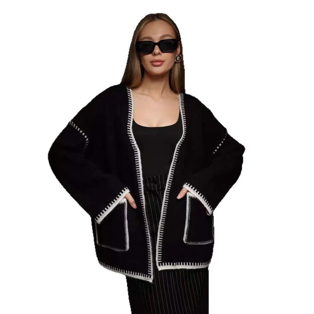 A loose, mid-length knitted cardigan with a front lace-up detail, shown in a camel colour.