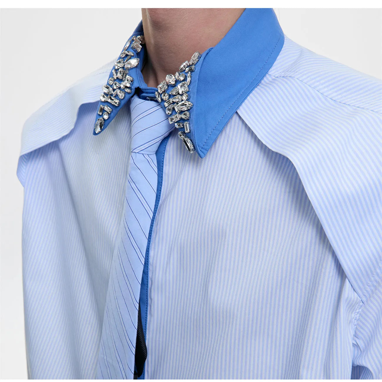 Man's blue patchwork striped shirt with a diamond tie front, quilted panels, and button decorations.