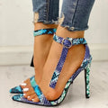 Blue women's high heels with buckle fastening and pointed toe in artificial leather