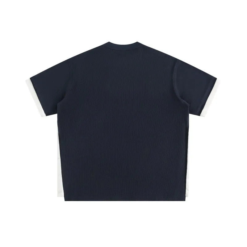 Retro alphabet embroidered loose waffle knit t-shirt in a fake two-piece style, shown in navy blue.