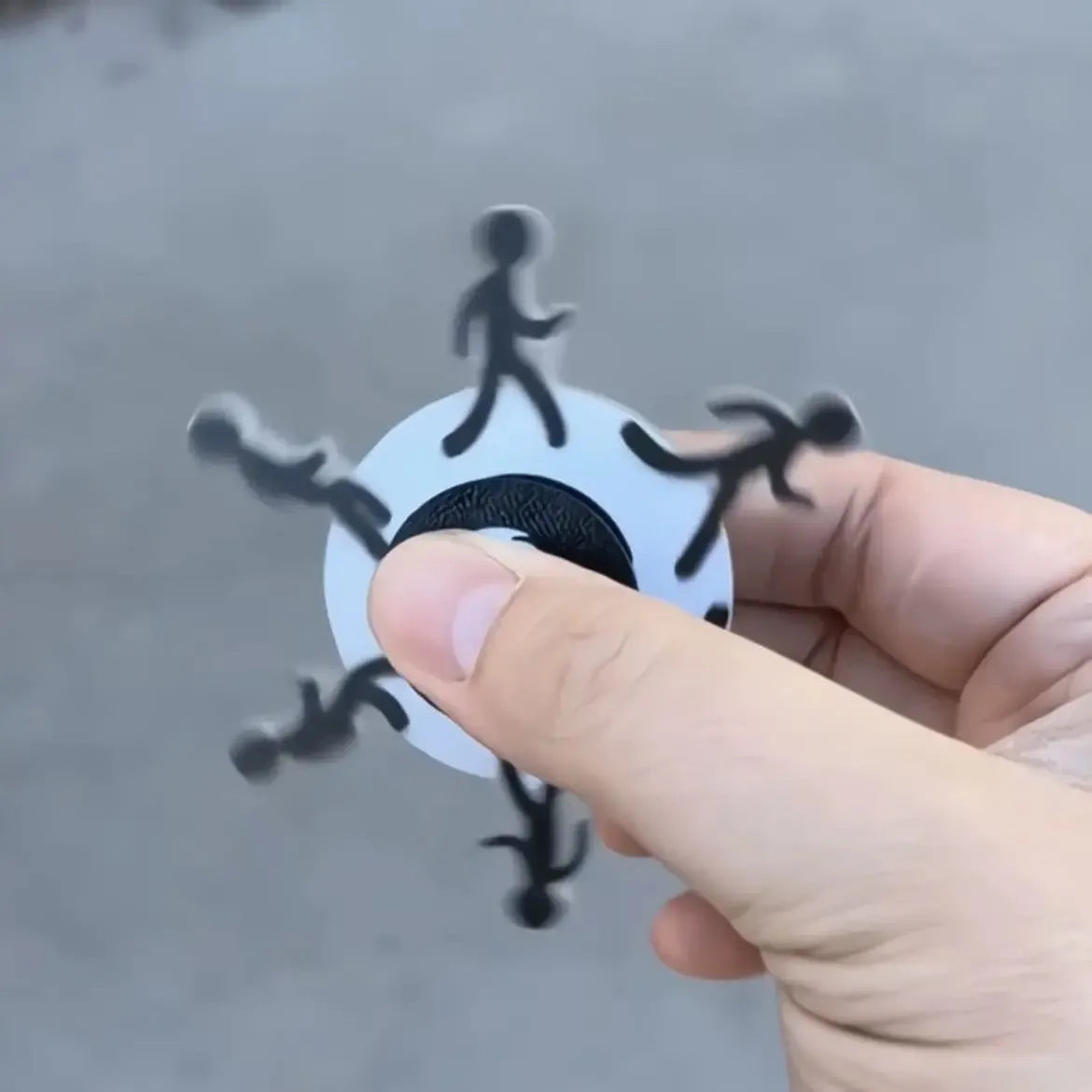 Colourful stickman running dynamic fingertip gyro on a white surface, spinning motion visible