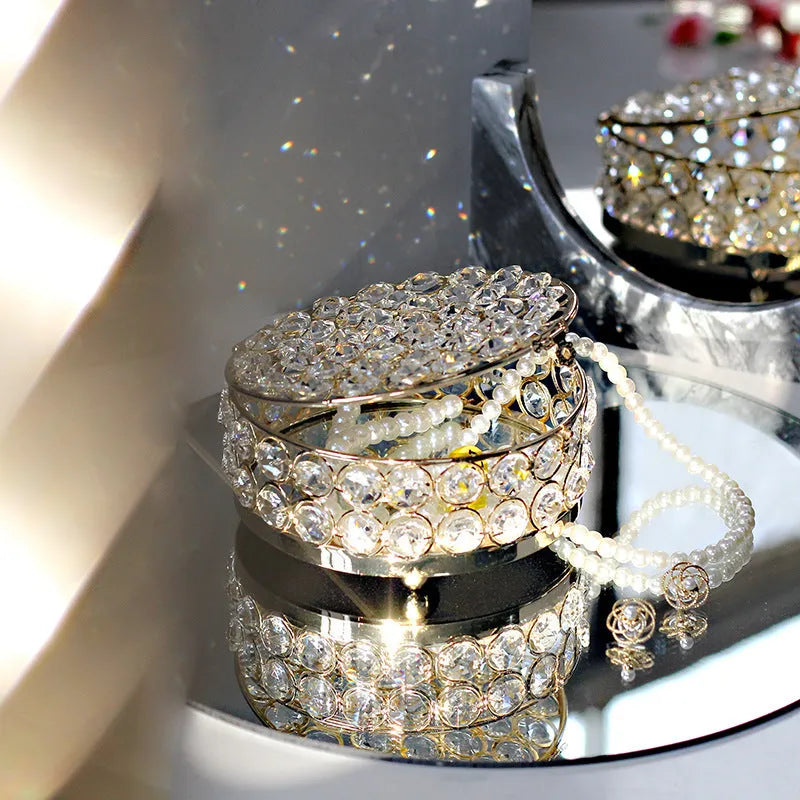 French gold iron frame crystal glass jewellery box with a metal lock closed.