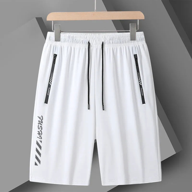 Man wearing black loose-fit quick-drying nylon sports shorts with a five-inch length.