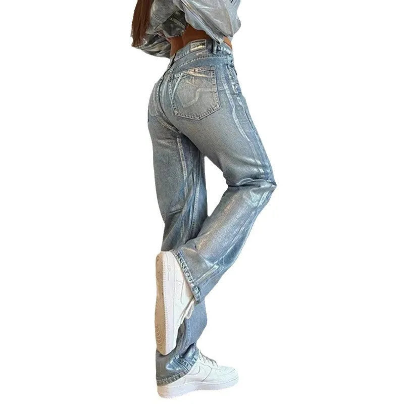 Blue high-waist straight-leg women's jeans with contrast colour detailing on a denim background.
