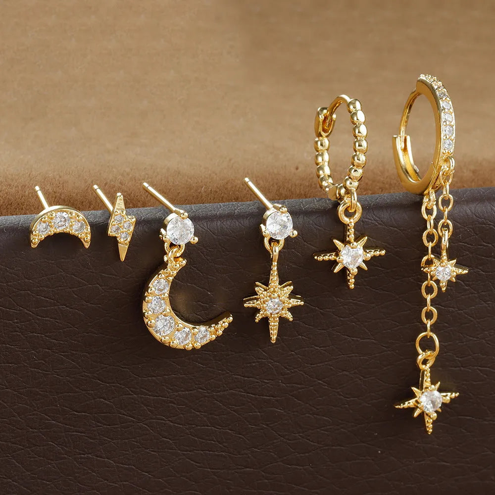 Six pairs of gold chain tassel earrings with zircon studs in display layout