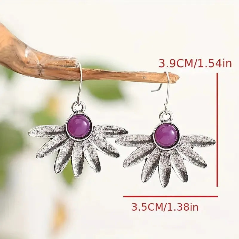 Purple resin Bohemian earrings with animal zodiac design on alloy metalwork.