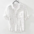 Men's loose fit black and white short sleeve polo shirt on a hanger