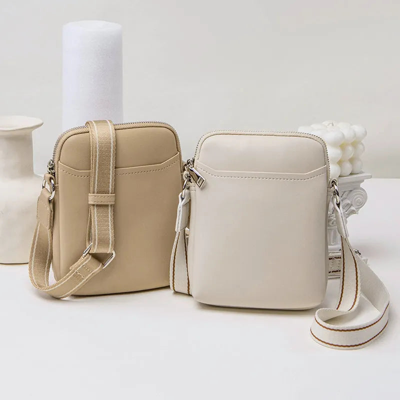 Small solid colour PU leather crossbody bag for women in black, shown with shoulder strap.