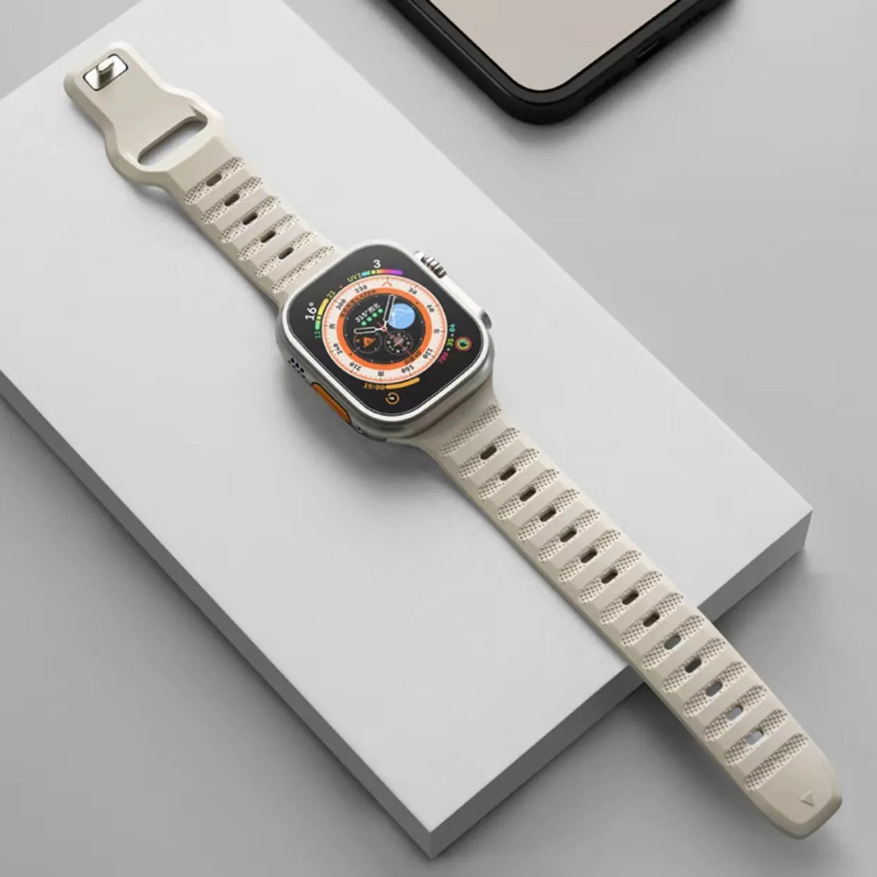 Fluoro rubber Apple Watch band in multiple colours on a grey background showing the T buckle clasp.