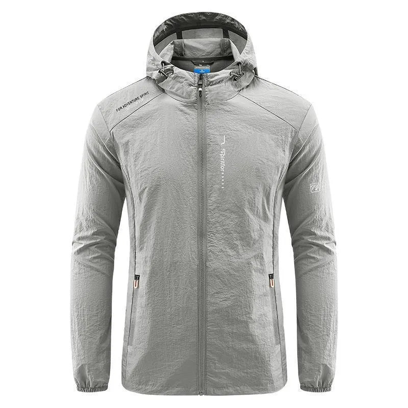 Man wearing a light grey loose-fitting hooded nylon summer jacket for sun protection.