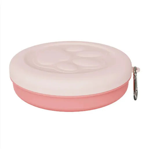 Portable outdoor dog bowl set in light green and pink, showing food bowl, water dish, and snack box compartment.