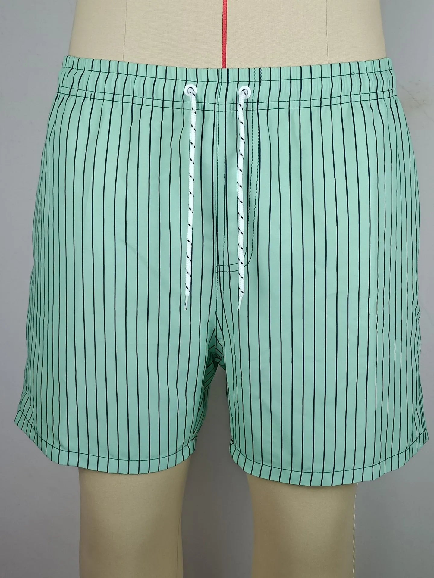 Men's striped polyester beach shorts in light blue with straight leg cut