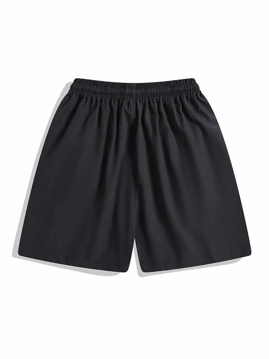 Man wearing loose-fit black quick-dry sports shorts with an elastic waistband.