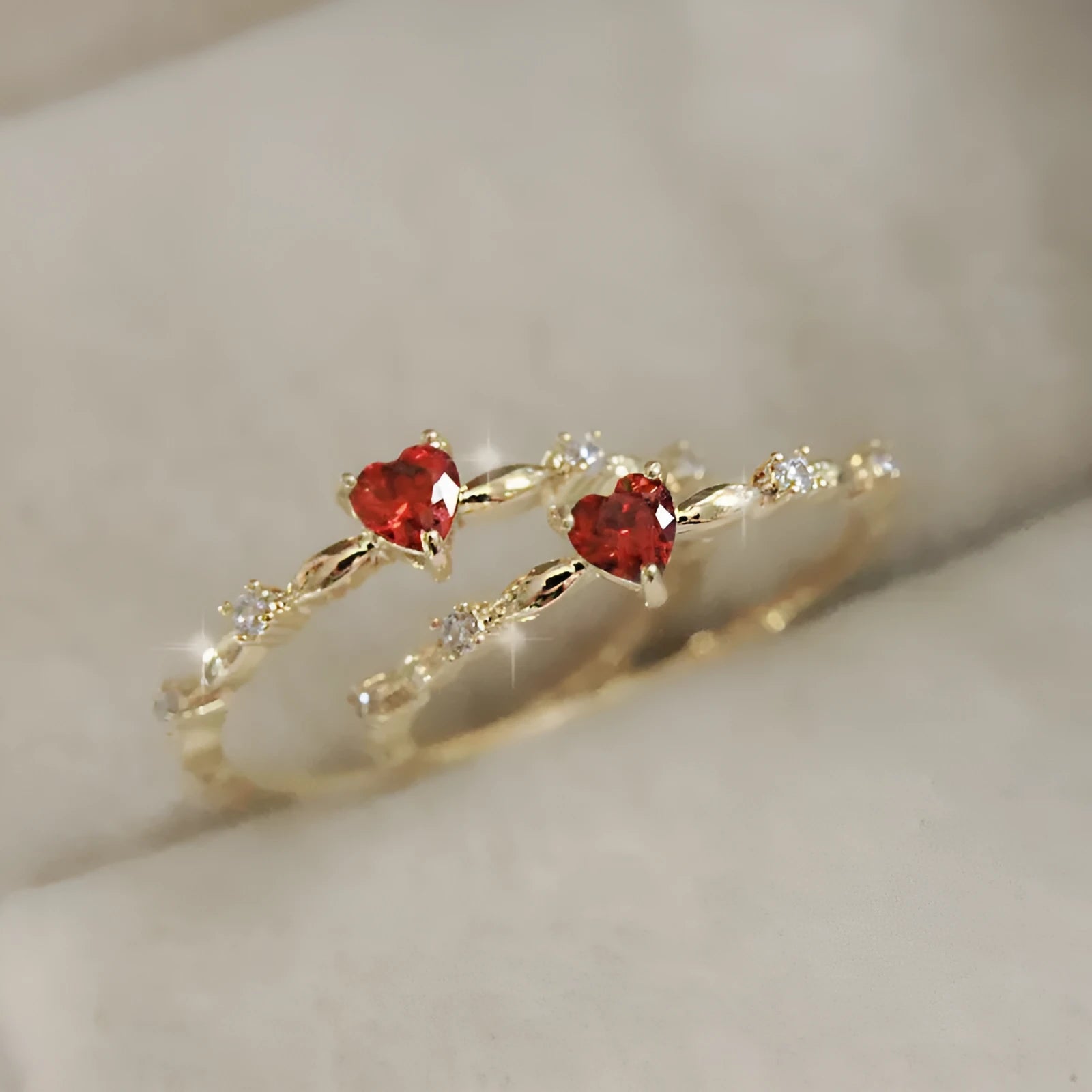 Personalised zircon peach heart ring in gold or silver finish on a copper band.