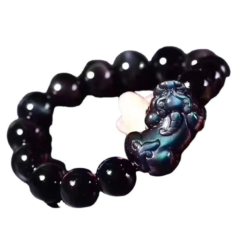 Natural ice colour polished obsidian crystal bracelet with adjustable closure on a wrist.