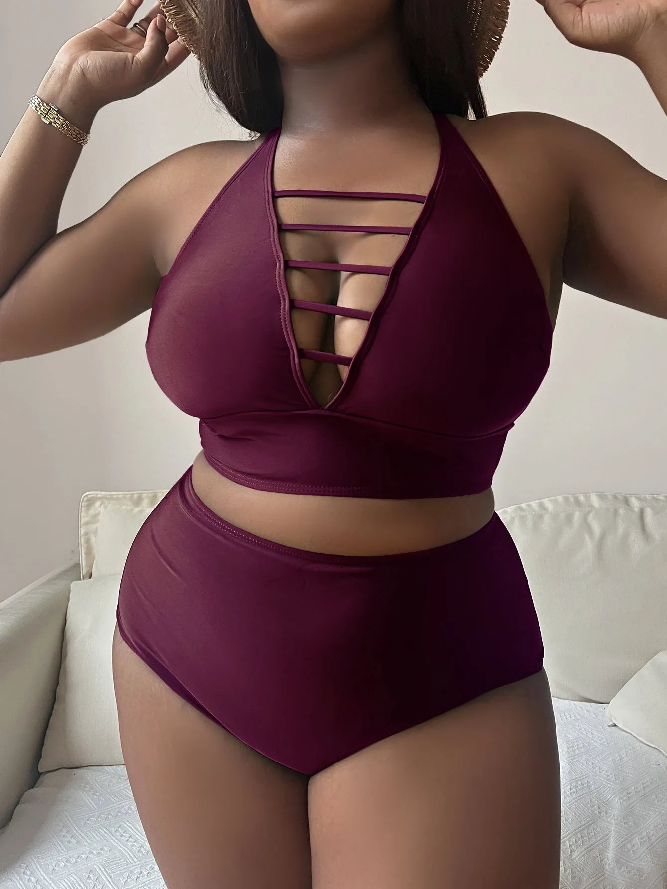 Plus size woman in black adjustable halter bikini with high-waisted briefs.