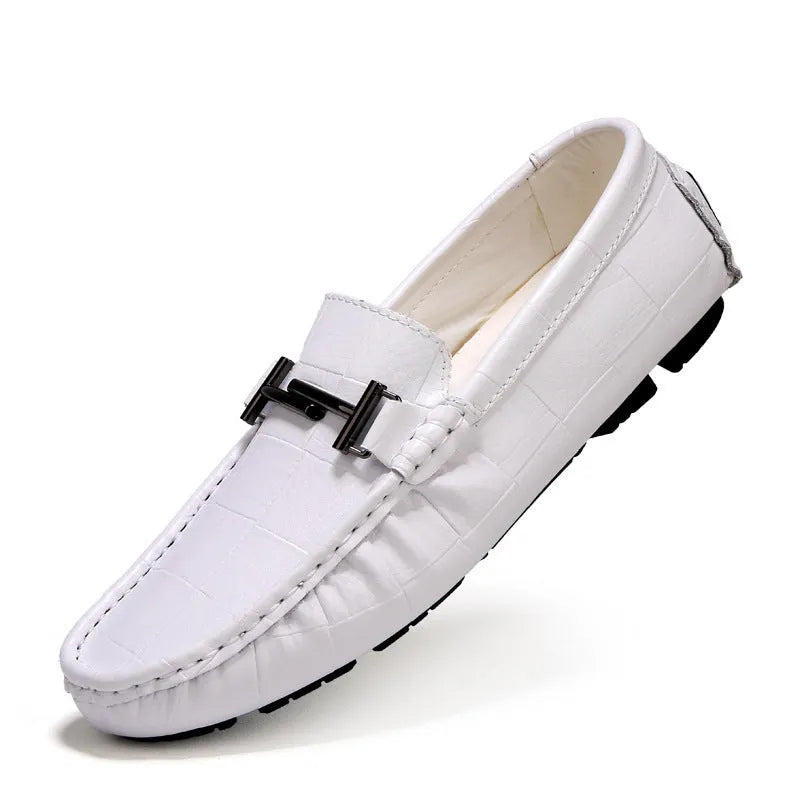 Men's low-cut leather casual shoe with a silver buckle fastener on a flat rubber sole.