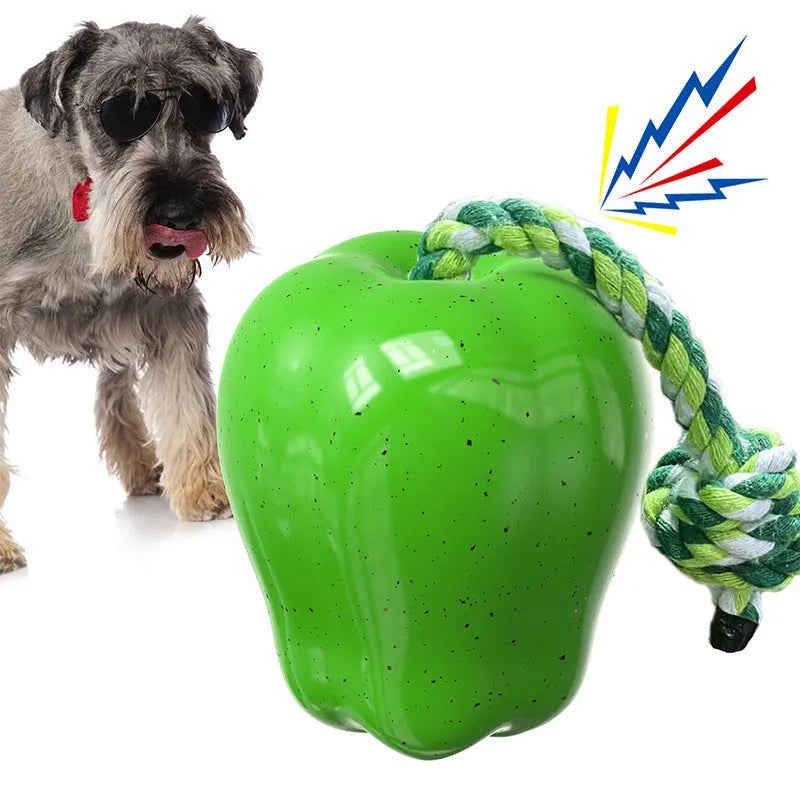 Red and green apple-shaped plastic dog ball with squeaker and treat-dispensing holes