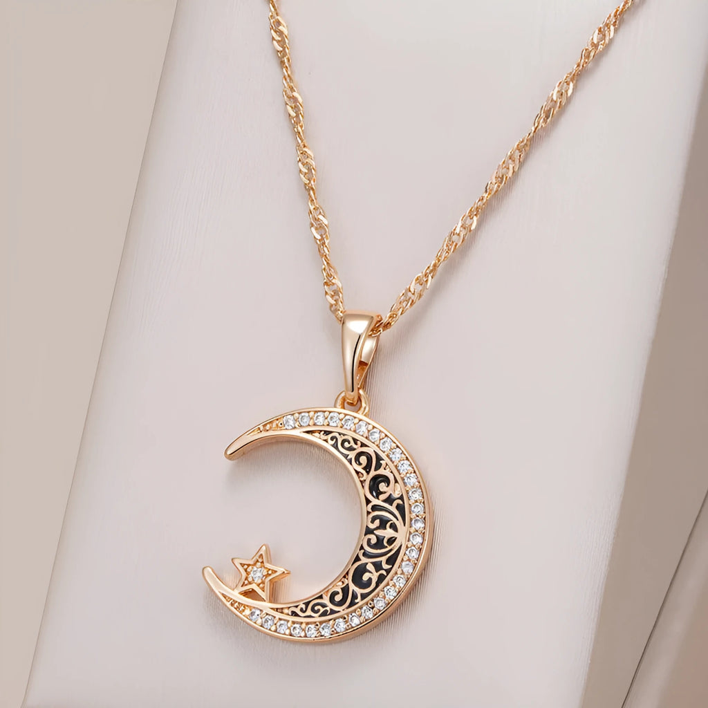 Rose gold star and moon necklace with enamel detailing on adjustable water wave chain