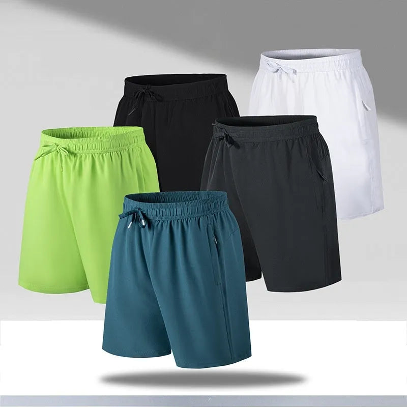 Man wearing loose-fit black quick-drying ice silk polyester sports shorts on a beach.