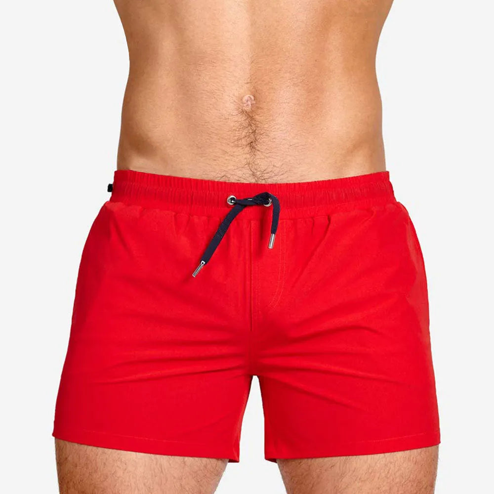 Solid colour polyester swimming and sports shorts with mesh lining in army green, on a white background.