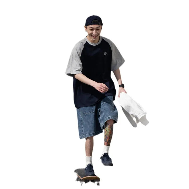 Man wearing a loose blue raglan sleeve casual t-shirt, Japanese style, thin polyester blend.