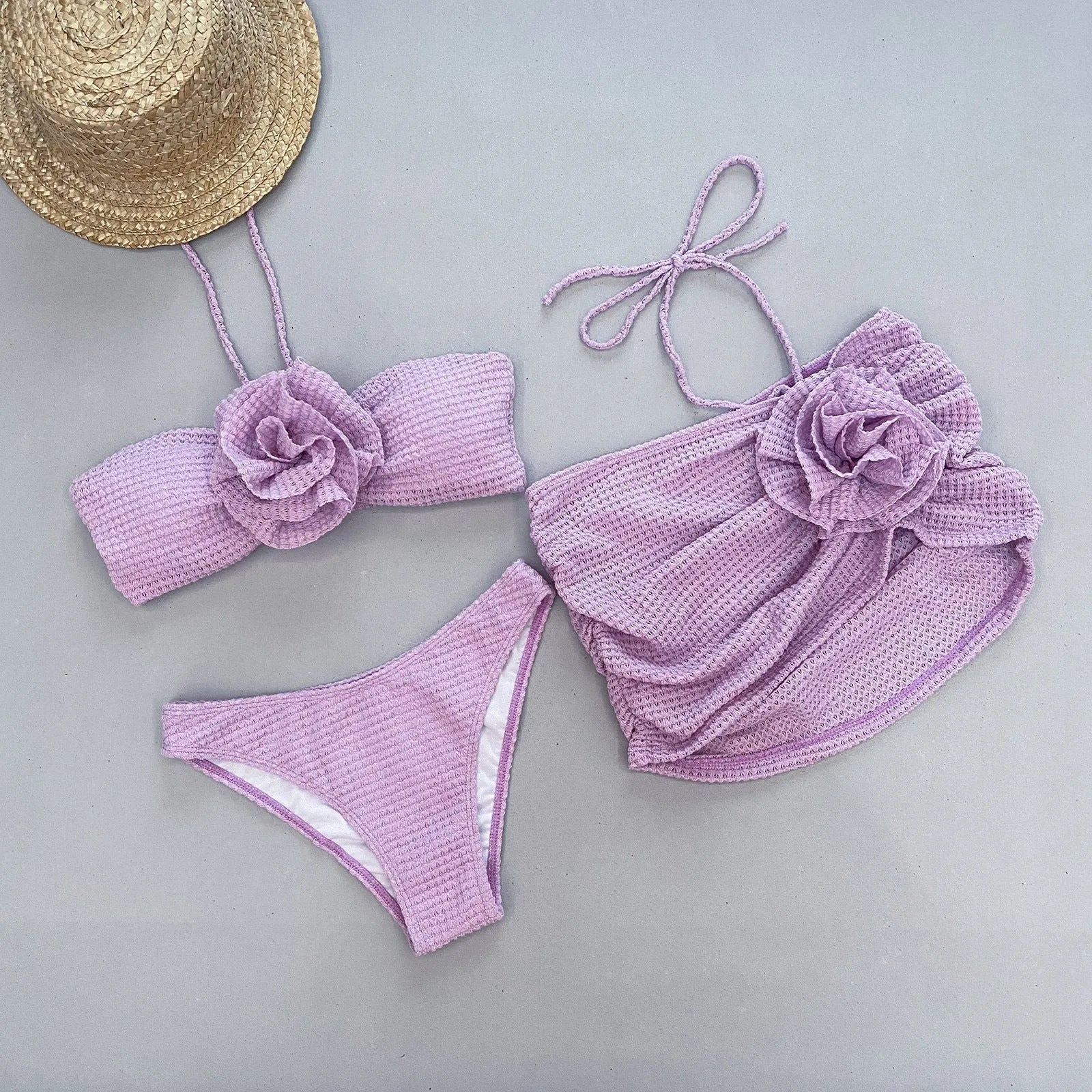Women's white three-piece bikini set with skirt, bra, and briefs for swimming