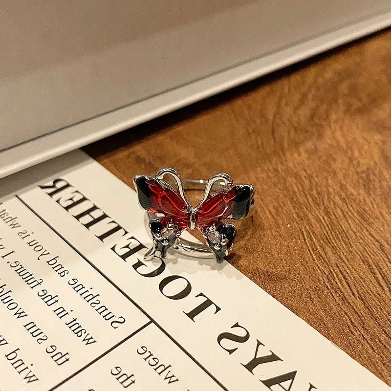 Copper butterfly women's ring with oil-drip finish showing open-loop design