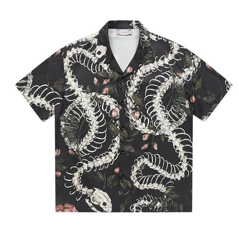 Man wearing a loose fit Cuban collar shirt with a printed snake bone and floral pattern in a summer setting.