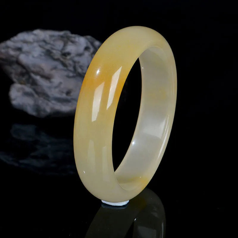 A polished light jade bracelet for women, shown in a Chinese style, with size options from 54mm to 62mm.