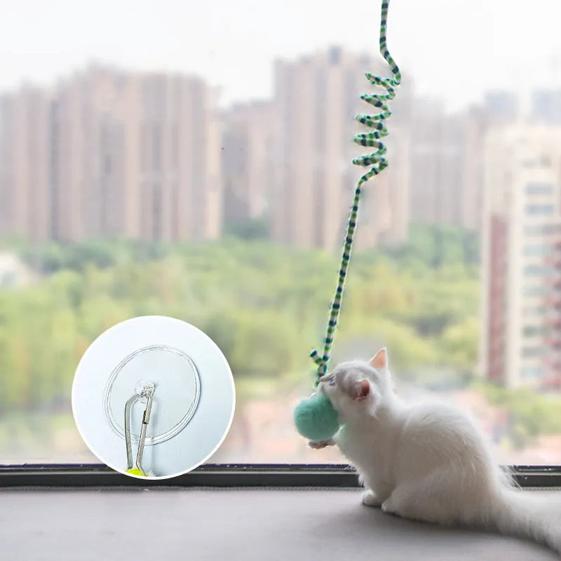 Hanging cat toy with suction cup, spring-mounted bell stick, and inflatable ball in multiple colour options
