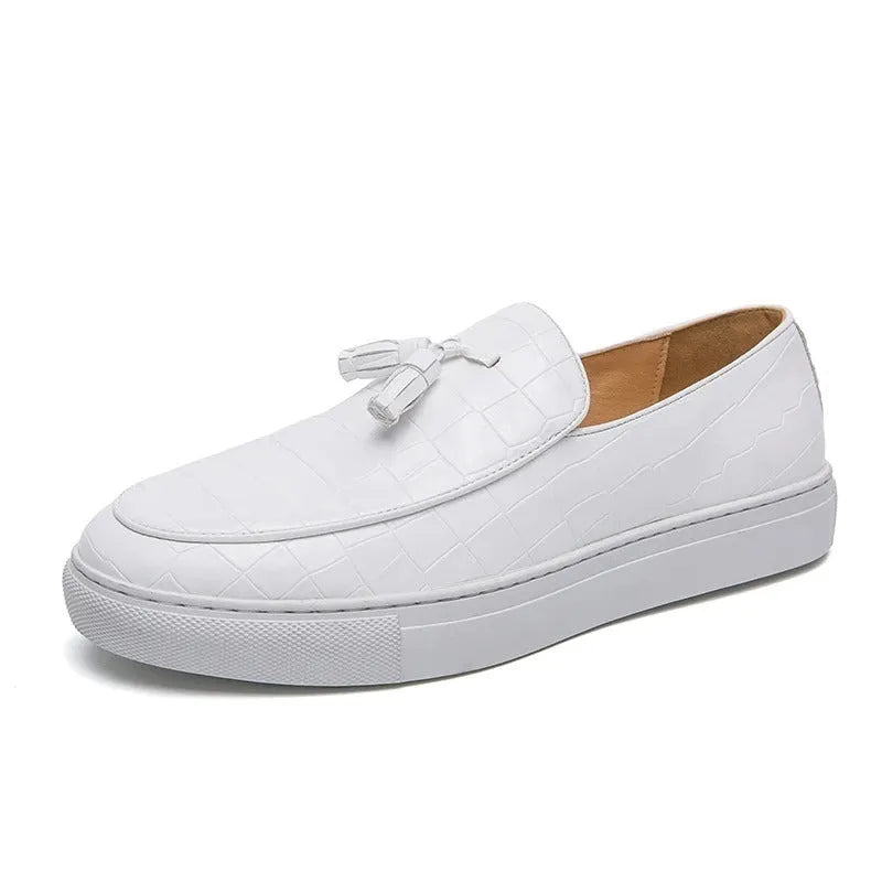 Men's brown artificial PU leather slip-on sneakers with a tassel detail on the round toe.