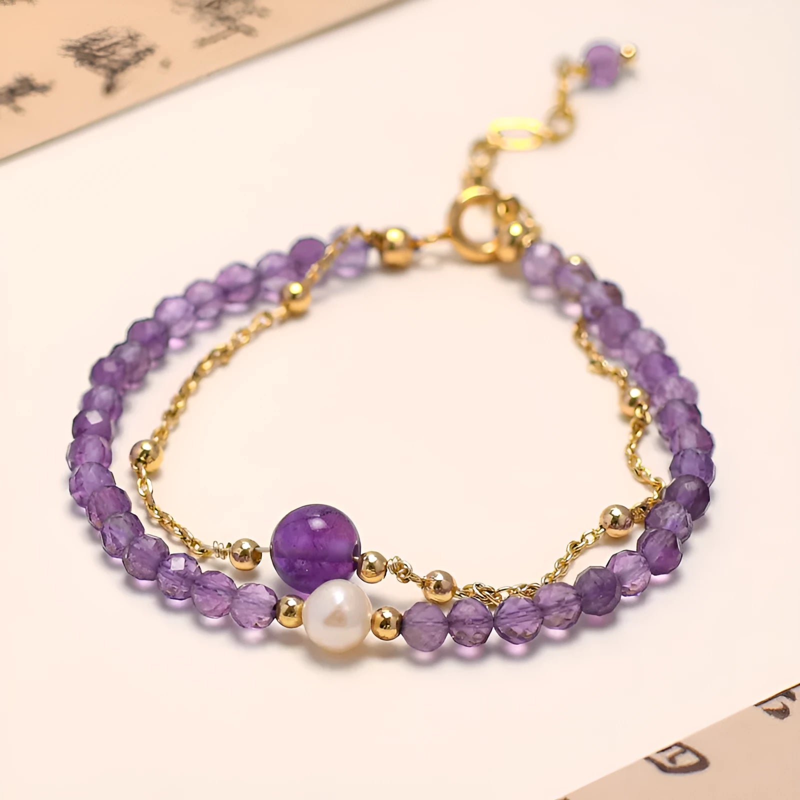 Chinese style women's bracelet with amethyst-coloured diamond-shaped crystals in electroplated metal setting