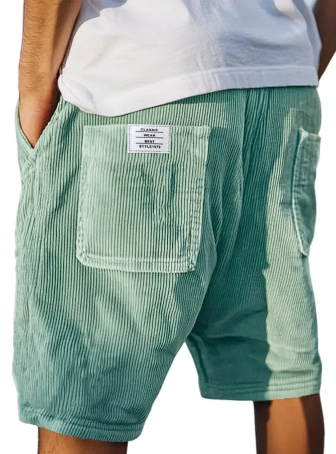 Men's grey straight-fit corduroy shorts with multiple pockets and a small embroidered logo on the leg.