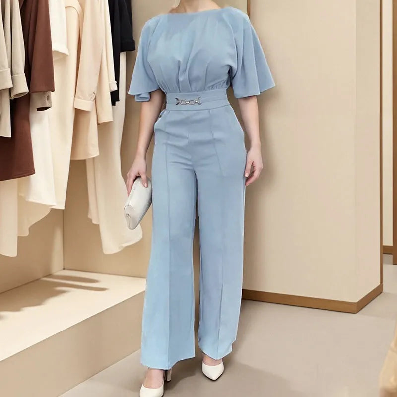 Blue two-piece polyester suit with long sleeves and trousers on a hanger