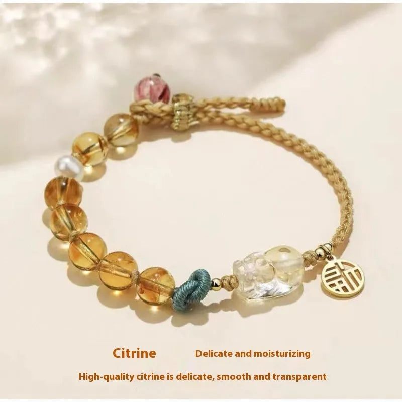 Hand-woven citrine crystal bracelet with zodiac animal design on wrist