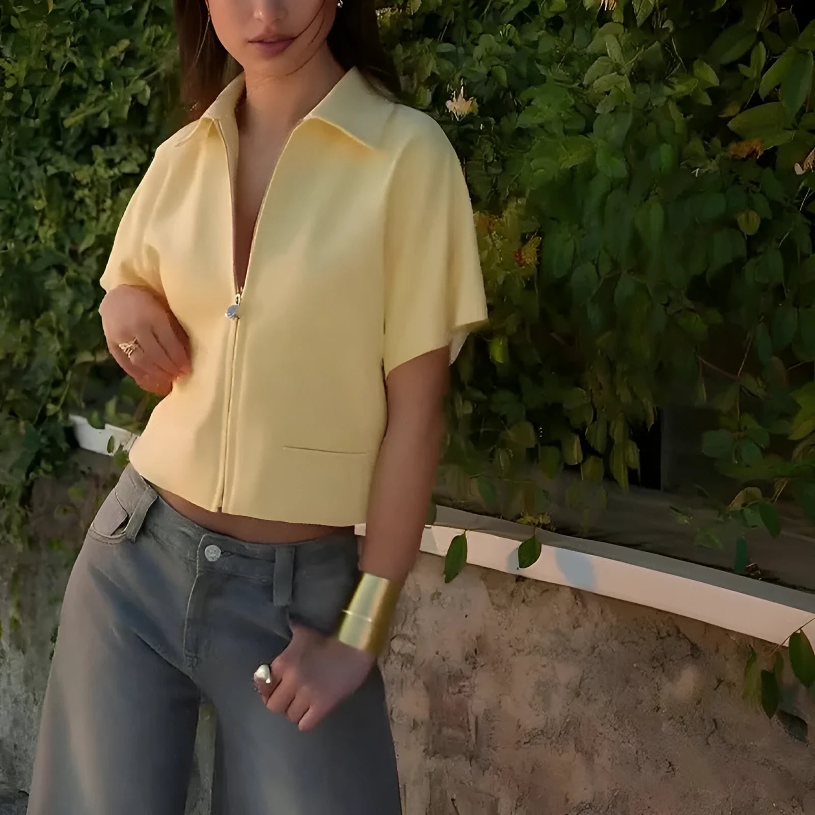 Loose fit casual polyester top in yellow on a hanger