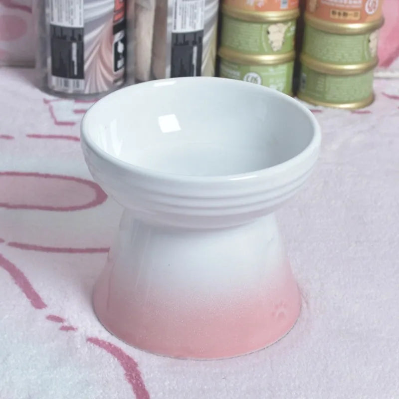 Black chin-high foot ceramic pet bowl for dogs and cats on a flat surface.