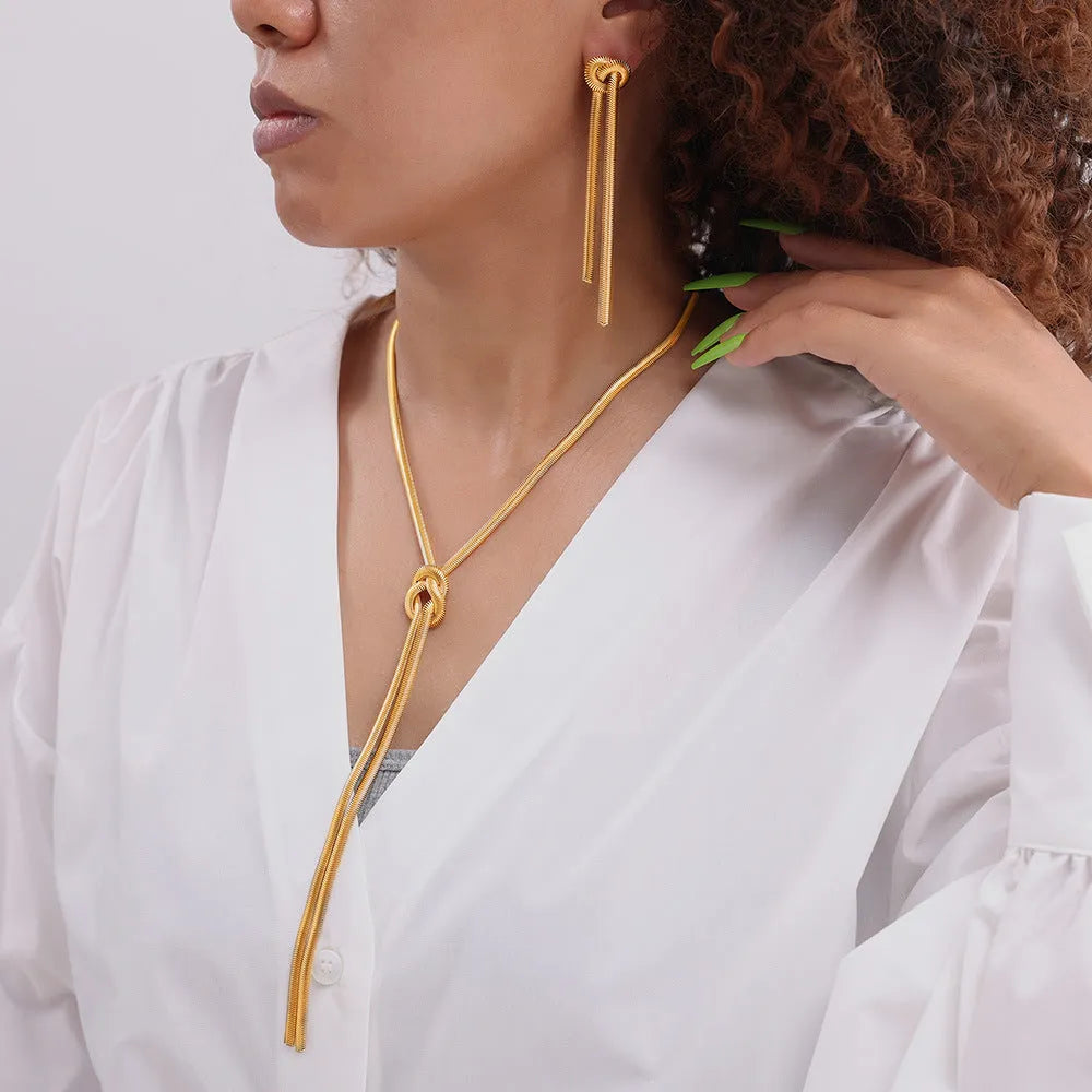 Gold knotted tassel necklace and matching earrings set on titanium steel snake chain