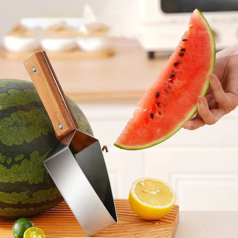 Stainless steel watermelon splitter with triangle cutting piece and protective cover on a kitchen counter.