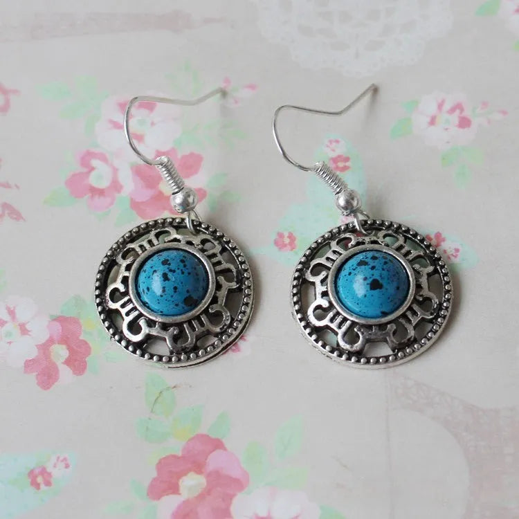 Miao ethnic silver earrings with geometric flower disk design and turquoise accents