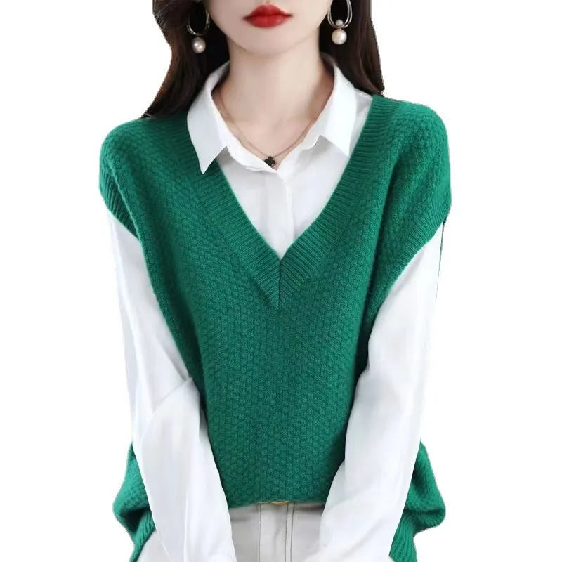 Sleeveless V-neck knitted pullover vest with a raised 3D pattern, shown in a selection of colours on a hanger.