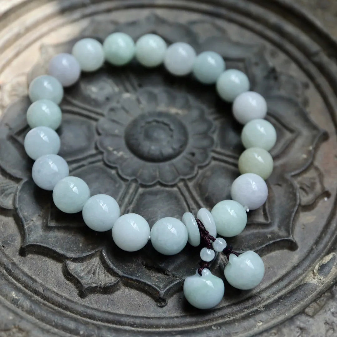 Natural jade Buddhist hanging bracelet showing geometric shape and symbolic charms