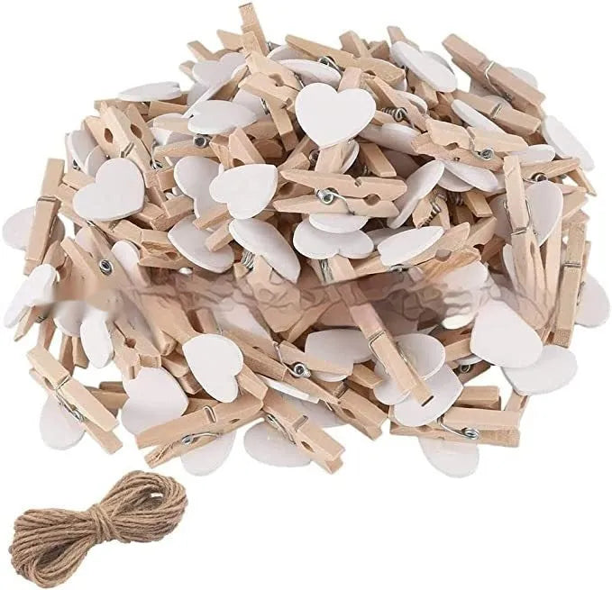 Set of five small wooden heart-shaped hair clips in various colours on a neutral background.