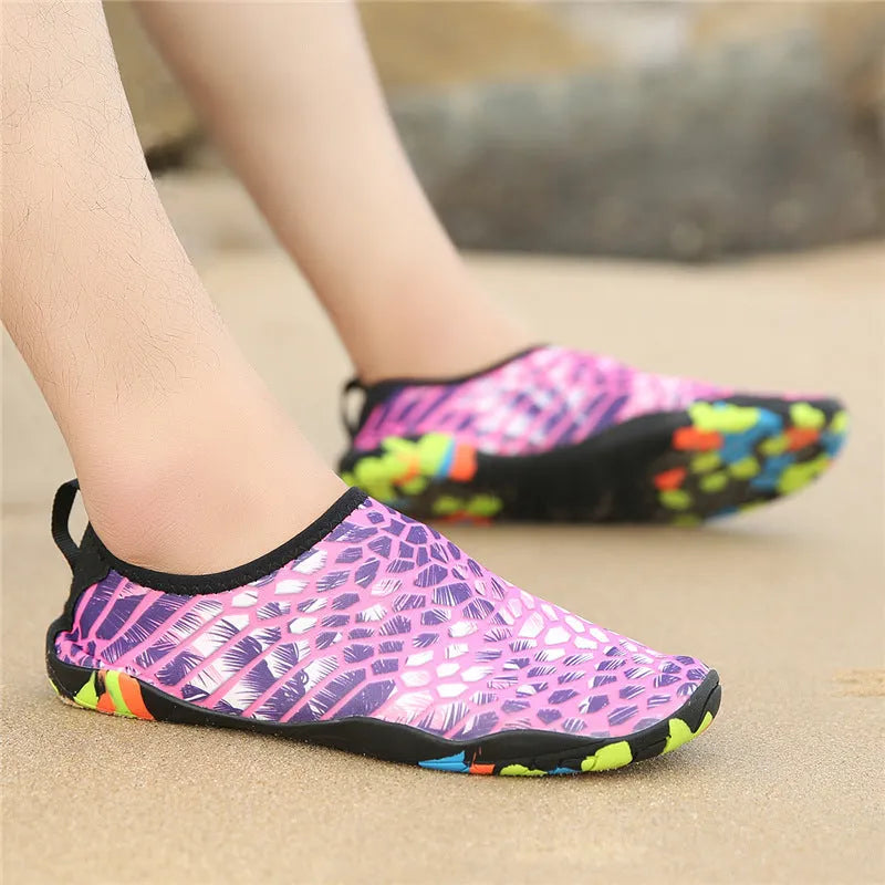 A pair of beach wading shoes for swimming, shown in camouflage colour with Lycra upper and EVA sole.