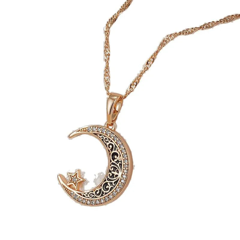 Rose gold star and moon necklace with enamel detailing on adjustable water wave chain