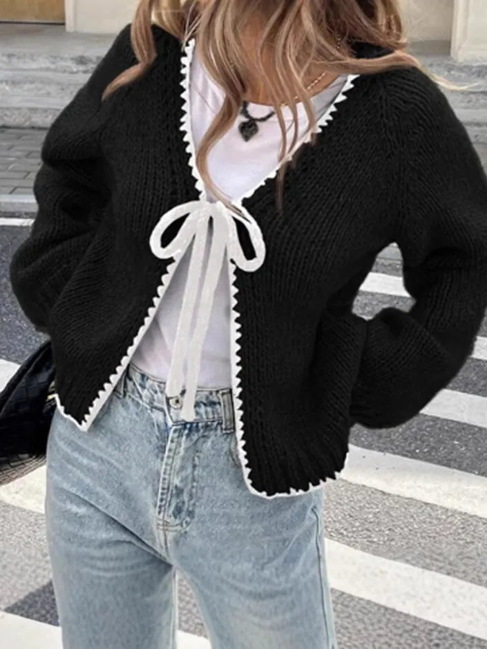 Gray lace-up front cardigan sweater with white crochet flower details and loose long sleeves.