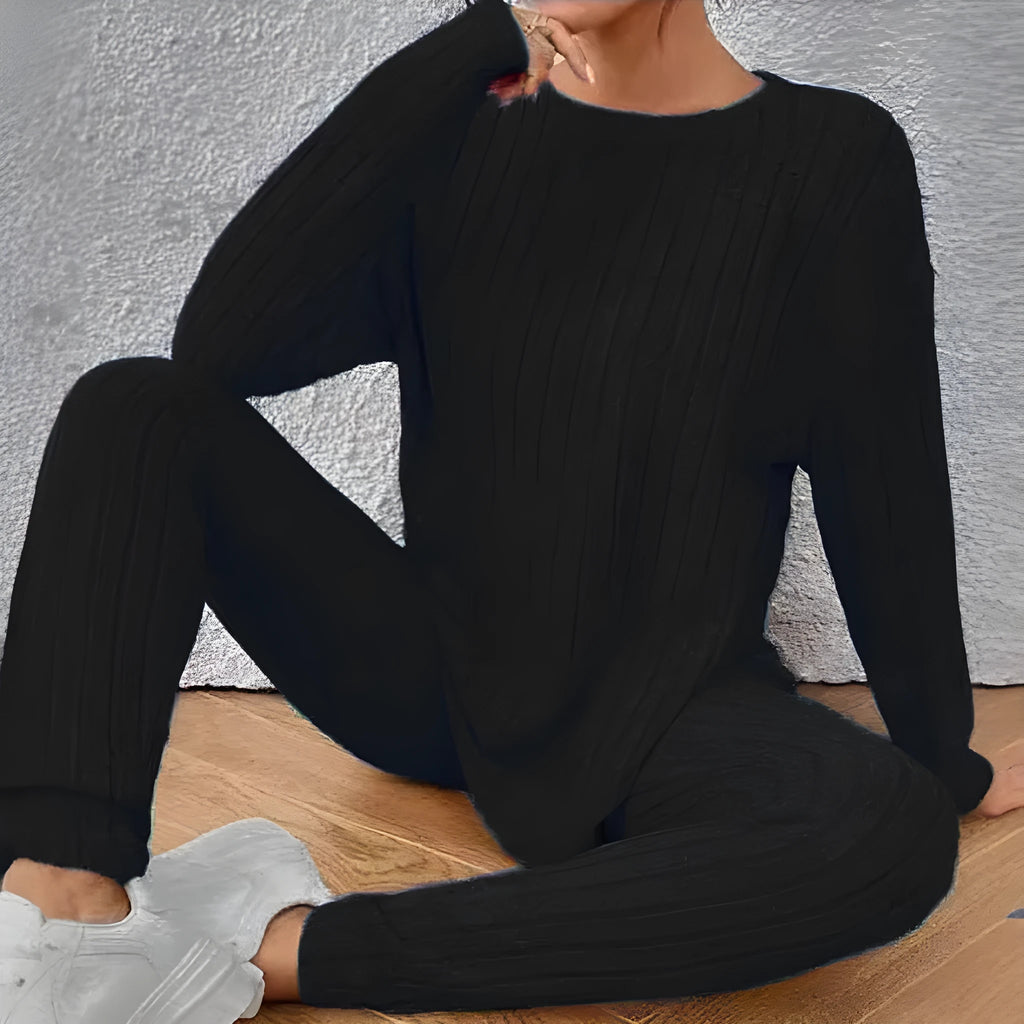 Black sunken stripe two-piece casual homewear set with top and pants on a hanger.