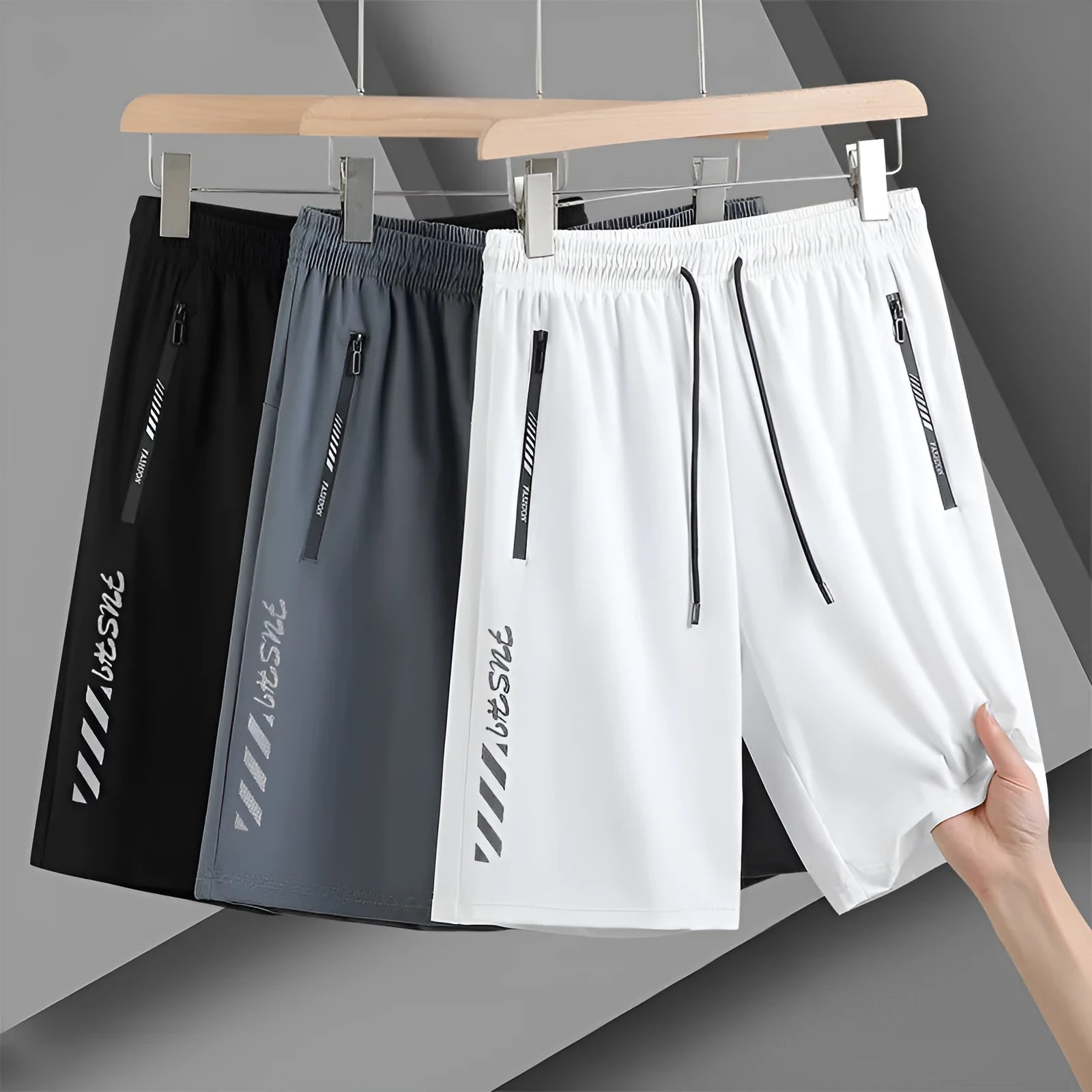 Man wearing black loose-fit quick-drying nylon sports shorts with a five-inch length.